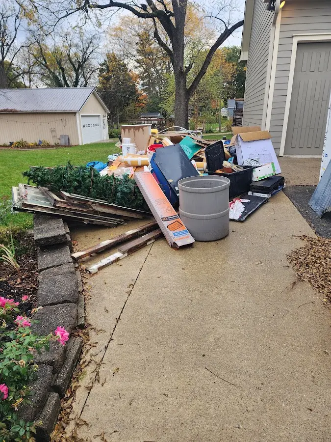 Dumpster being loaded with debris for Estate Cleanout Dumpster Rental in Prospect Park